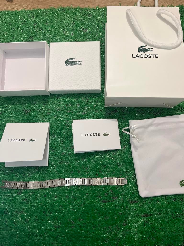 Merk Lacoste .Armband Nieuw met complete verpakking!, Ophalen of Verzenden, Nieuw, Zilver, Staal