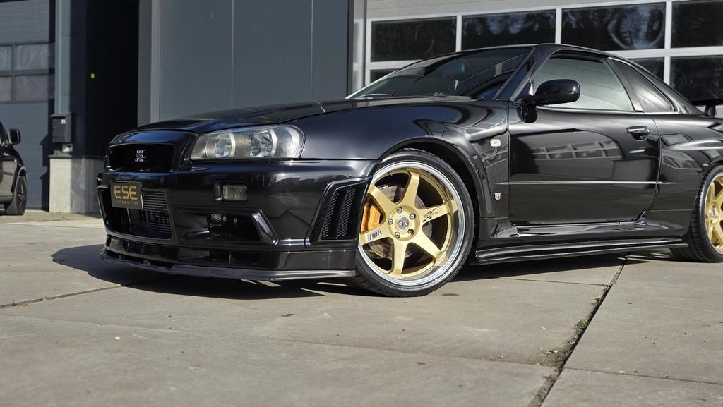 Nissan Skyline R34 GTR V-spec LHD (UK-Spec) 1 of 80, Auto's, Stof, Zwart, 2568 cc, Zwart