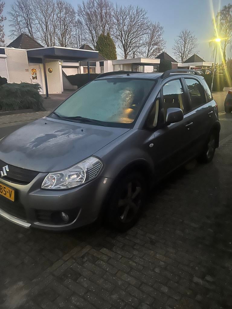 Suzuki SX4 1.6 AUT 2007 Grijs, Auto's, 4 cilinders, 49 €/maand, 1200 kg, Particulier