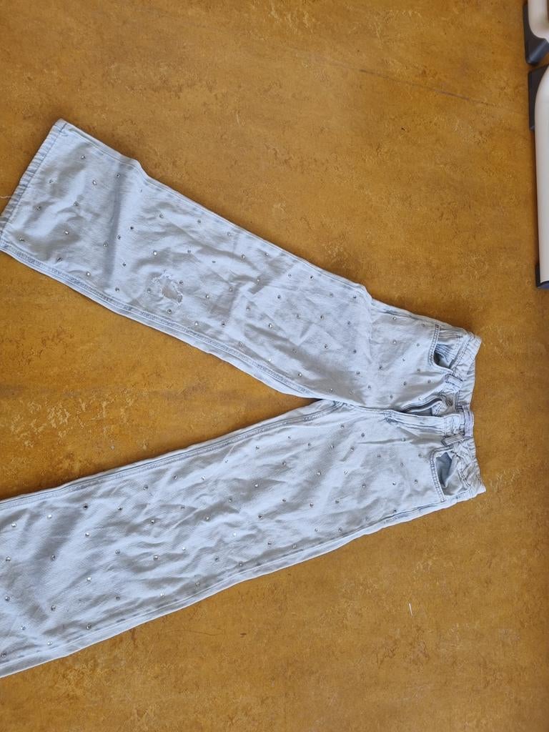 Lichtblauwe broek met steentjes, Ophalen