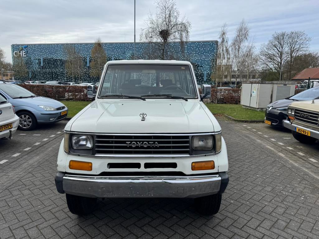 Toyota landcruis RJ77 benzine 1994, Auto's, Toyota, Stof, Beige, 4 cilinders, Wit