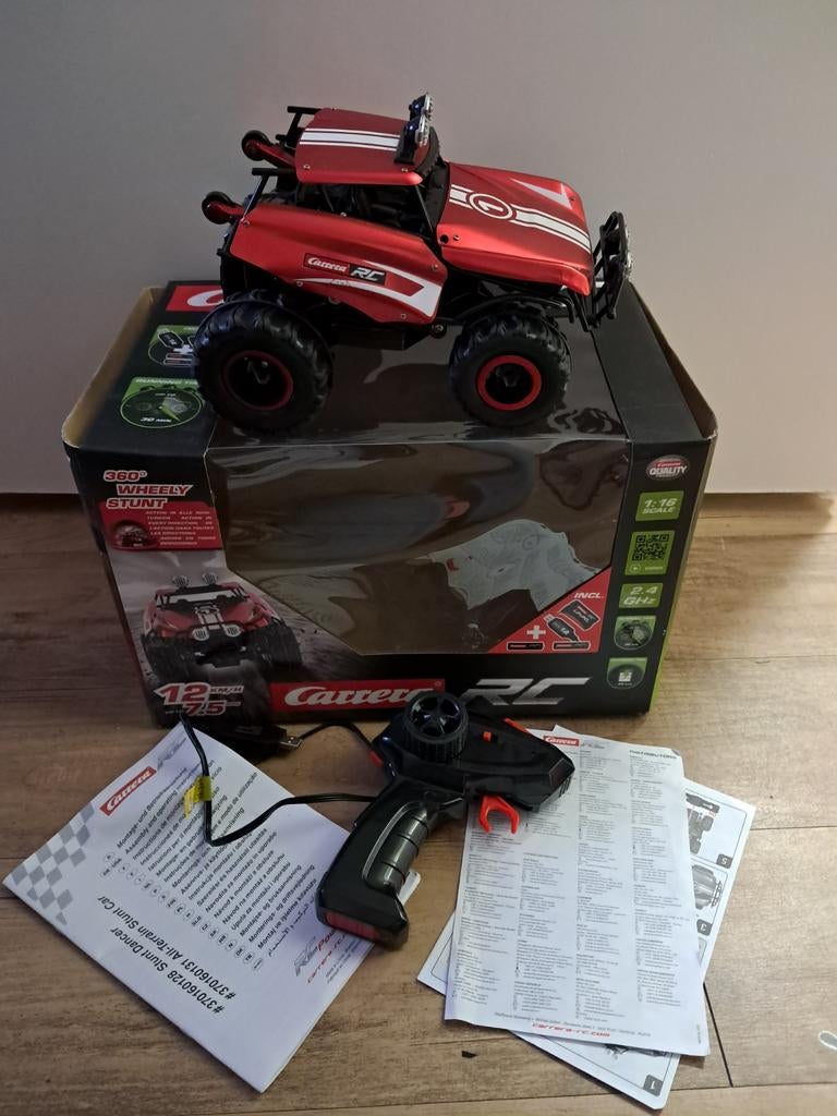 Carrera rc 360 graden wheely stunt met doos, Ophalen of Verzenden, Zo goed als nieuw, Overige schalen, Auto offroad