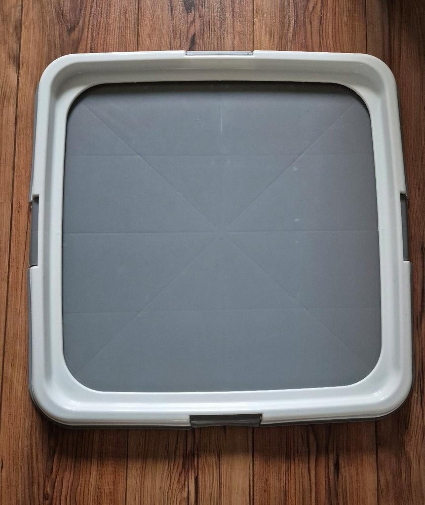 Zindelijkheidstraing bak voor plaspad, Ophalen