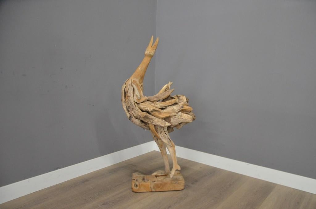 Handgemaakte teak vogel, Ophalen