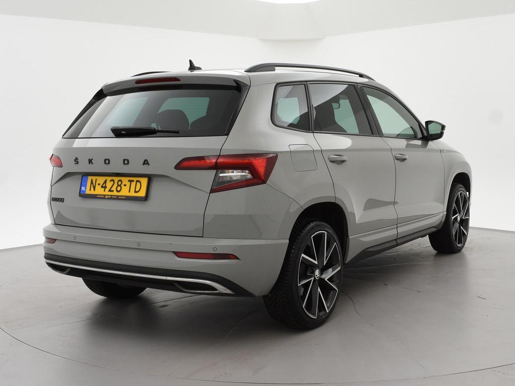 Skoda Karoq 1.5 TSI ACT 150 PK DSG SPORTLINE + CANTON AUDIO, Auto's, Stof, 4 cilinders, 19 km/l, Adaptive Cruise Control