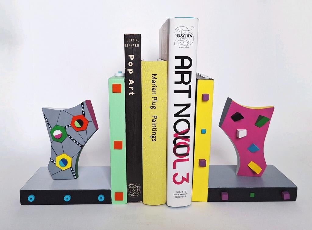 2 kleurige boekensteunen., Ophalen of Verzenden