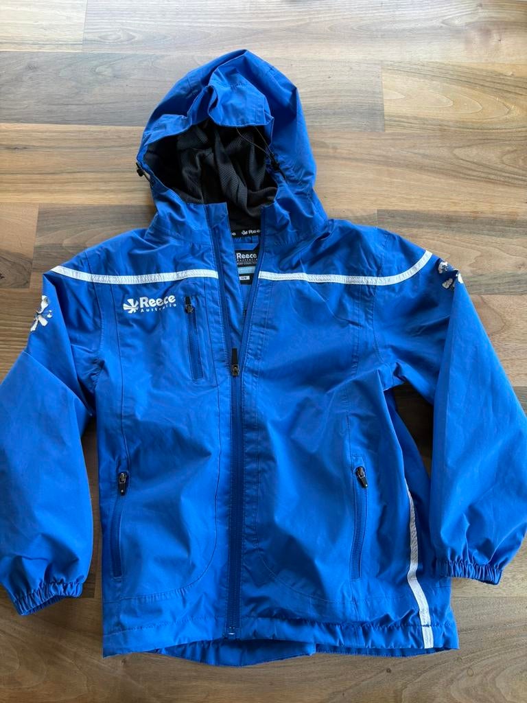 Hockey jasje Reece maat 128, Ophalen, Zo goed als nieuw, Regenjas