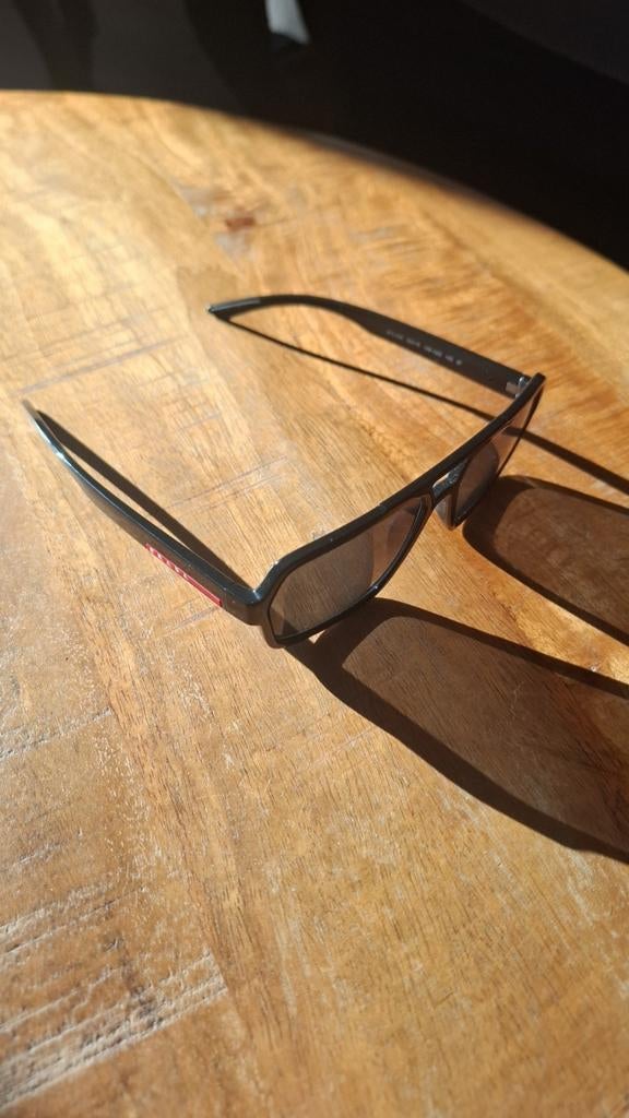 Prada linea rossa zonebrill, Ophalen